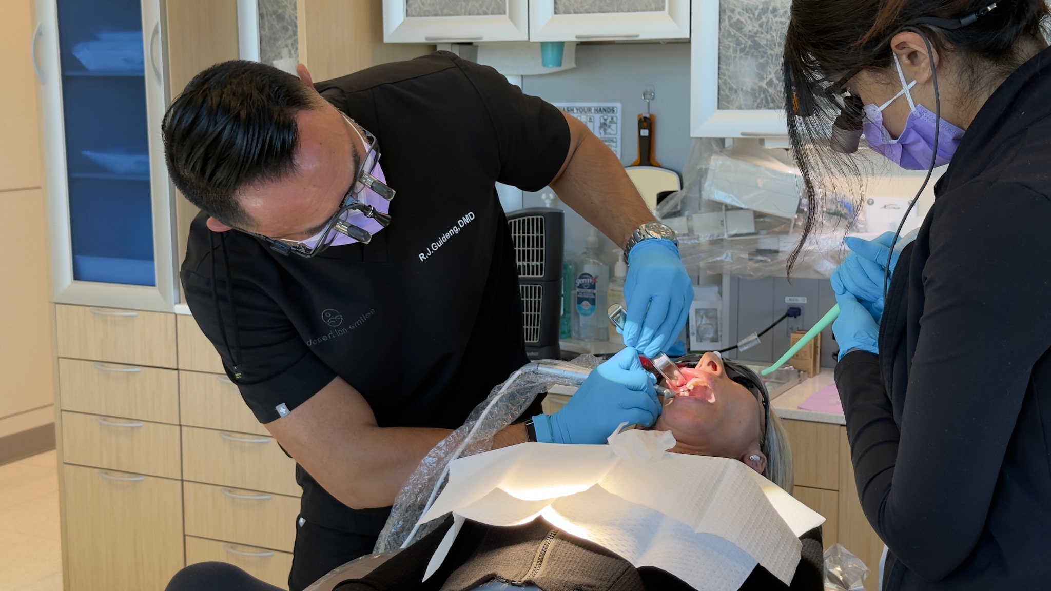 Dr. R.J. working closely with his patient